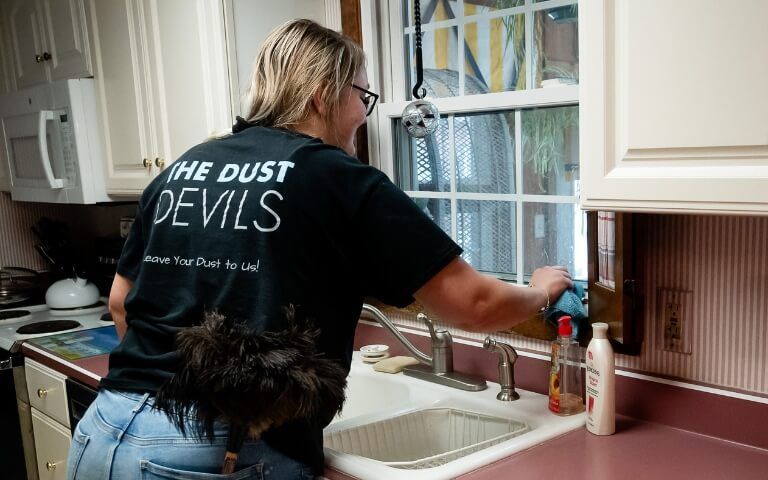Cleaning tech washing kitchen sink